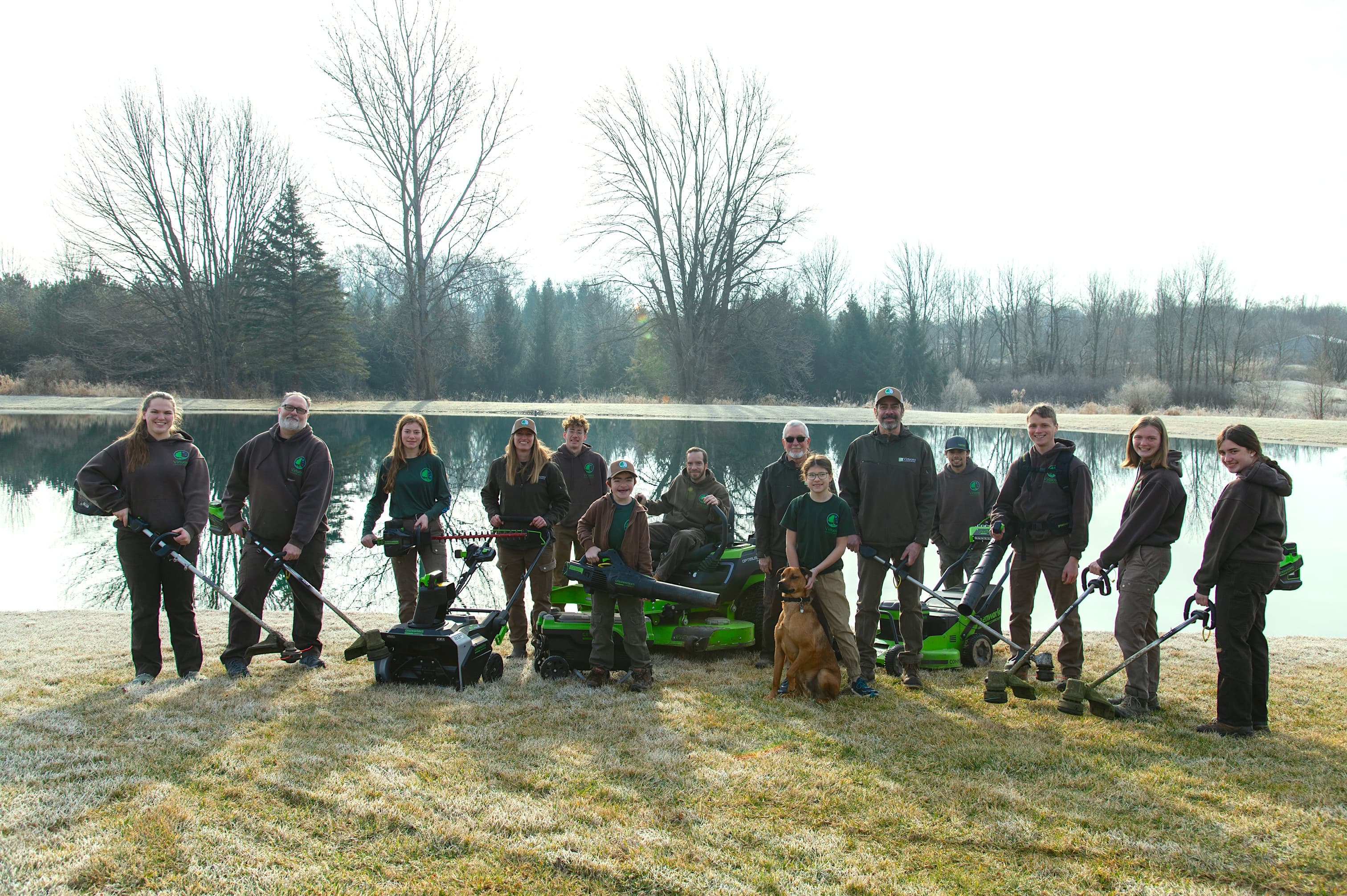 Virtuoso Landscaping team holding electric equipment